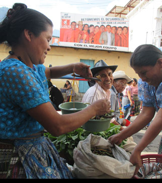 Photo of a woman weighing vegetables in Guatemala